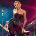 Detail of black strapless top with oversized bow and shimmering sequins on stage - XS / Black