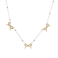 Detail of rose gold necklace featuring polished beads and three delicate bow pendants - Rose Gold