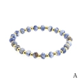 4mm faceted amazonite stone bracelet with polished gold plated metal beads on white background - Blue Spot Jasper