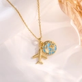 Detail of gold necklace featuring airplane and blue enamel globe charms on silk - Gold Earth Airplane Style