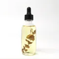 A 60ml clear glass dropper bottle of essential oil with dried botanical sprig inside - Eucalyptus Oil