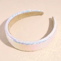 Detailed view of pink sparkling sequins on a wide headband for women against a soft pink background - Lavender