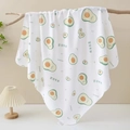 Soft cotton baby swaddle blanket with cute avocado print hanging on a wooden branch - Avocado Trio