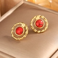 Close-up of vintage 18K gold earrings featuring red stone beads and braided textures - Gold + Red Turquoise