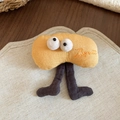 Detail of yellow plush biscuit brooch with big eyes and embroidered lettering on linen - Yellow Long-legged Character (Biscuit) / Yellow