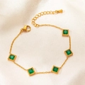 Detailed macro view of gold chain bracelet featuring square emerald green gemstones on silk - Green Rhinestone Square Block Style