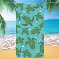 Microfiber beach towel featuring a teal sea turtle print hanging on a sunny tropical beach - Sea Turtle Beach Towel 5
