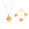 Golden jewelry set with textured flower pendant necklace and matching bracelet for women - Gold Necklace & Bracelet Set