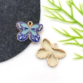 Macro detail of enamel butterfly pendant with blue patterns and golden textured back - Drip Oil Blue Flower Butterfly