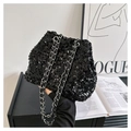 Close-up of black sequined bucket bag with a silver chain strap and shiny texture - Black