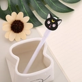 Cute white gel pen with a black cartoon cat topper on a decorative desktop setting - White Barrel Black Cat
