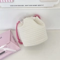 Close-up of quilted cotton drawstring pouch with floral lining and pink braided cords - Baby Cotton White