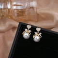 Elegant gold bow earrings with heart crystal and large white pearl drops on velvet display - E5449-5-Gold Bow Heart Pearl Drop