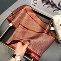 Pink silk scarf with geometric weave patterns and red wide borders in a luxury display - Intertwined Wheat Ears