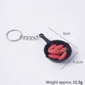 Miniature black frying pan keychain with realistic red sausages and metal ring - Sausage Pan - Keychain