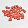 Macro shot of 10mm red heart beads with LOVE engraving for DIY jewelry making - Red