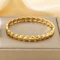 Dettaglio del bracciale dorato lucido con maglie a cuore su una scatola da gioielli - Stile Cuore Collegato (KB202826-SP)
