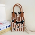 Detail view of the knitted dachshund crossbody bag featuring brown stripes and snap button - 23 Phone Bag-Brown Striped Dachshund