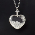 Detail view of heart-shaped glass pendant with white crystal gravel and silver chain - Silver & White Crystal