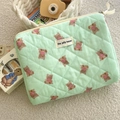 Detail of light green quilted cotton makeup bag featuring cute brown bear patterns and zipper - Clutch Bag / Mint Green Bear