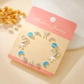 Silver earring set with blue enamel heart and star patterns on a pink card - Silver Blue Starry Sky (E1931-1)