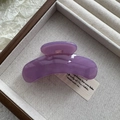 Close-up of a glossy purple acrylic hair claw clip on a rustic linen and wooden tray - Fruit Purple