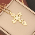 Macro view of 18K gold-plated cross pendant with pink heart cubic zirconia in a jewelry box - Pink