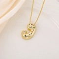 Macro shot of 3D puffy gold letter J pendant inlaid with colorful round cubic zirconia - Letter J