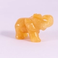 Carved yellow gemstone elephant statue with upwards trunk and polished finish - Topaz