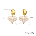Detailed view of polished gold stainless steel earrings with cream heart pendant charms - Bean Shape Heart Drop / Gold