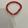 Red beaded phone charm with crystal accents and silver diamond spacers on white background - Red Faceted Beads White Buckle