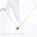 Golden birthstone necklace with round yellow zircon pendant on white mannequin - November Light Yellow