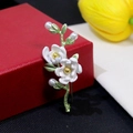 Detail of floral pearl brooch with white flowers and green enamel leaves on gift box - Double White Flower Style (XZ215)
