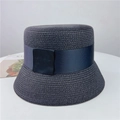 Detail of elegant straw bucket hat with fine weaving and wide ribbon bow tie decoration - M (56-58cm) Adjustable / Black