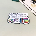 White enamel social battery pin with laptop, game controller and book icons - Special Interests