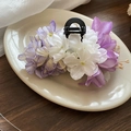 Elegant white and purple silk flower shark clip hair claw on a ceramic tray - Purple Flower Hair Claw
