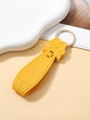 Detailed view of yellow PU leather pig keychain with cat head charm and golden metal ring - Yellow