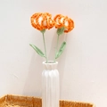 Handmade crochet orange carnations in white ceramic vase inside a woven basket - Carnation (Single Finished) / Gradient Orange (Long Leaf)