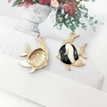 Macro view of gold-plated angelfish pendant showing enamel front and textured metal back - Tropical Fish