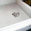 Macro shot of silver ring with double C design paved with white zircons in a jewelry box - 22# Intertwined Double C Design