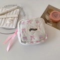 Detail of quilted floral makeup bag with pink ribbon zipper and elegant isocute label - White