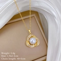 Macro detail of bird nest pendant with white pearl and zircon inlay on golden chain - Hollow Bird Nest Pearl Necklace (F349)