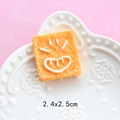 Macro shot of 2.4x2.5cm resin toast bread charm with smiling face for DIY crafts - Funny Expression Bread