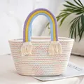 Detailed shot of a woven tote bag with rainbow handles and stylish tassel accents - White