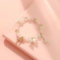 Pink and green beaded bracelet with gold bow and lily of the valley floral charms - S018-green Bow Lily Of The Valley Bracelet #sz188