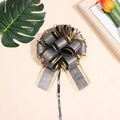 Detail of black gold mesh bow ribbon with bark texture and elegant golden edges - Black