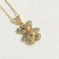Golden bear pendant necklace with white zircon and sky blue accents on cross chain - Blue Zirconia