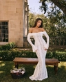 Elegant white lace off-shoulder mermaid maxi dress with long flared sleeves - S / White