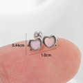 Silver heart stud earring with pink opal inlay shown on finger for scale, 1.0cm width - Silver-White Heart