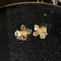 Detail view of gold vintage triangle earrings with diamonds on a textured plate - 66# Gold Irregular Metal Petal Earrings (66# Silver Earring Post-Gold-Flower)